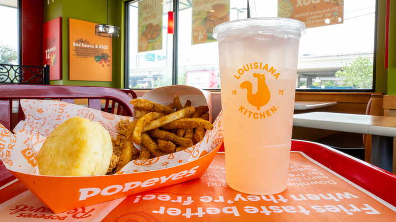 A Popeyes meal with chicken, biscuit, fries, and a drink
