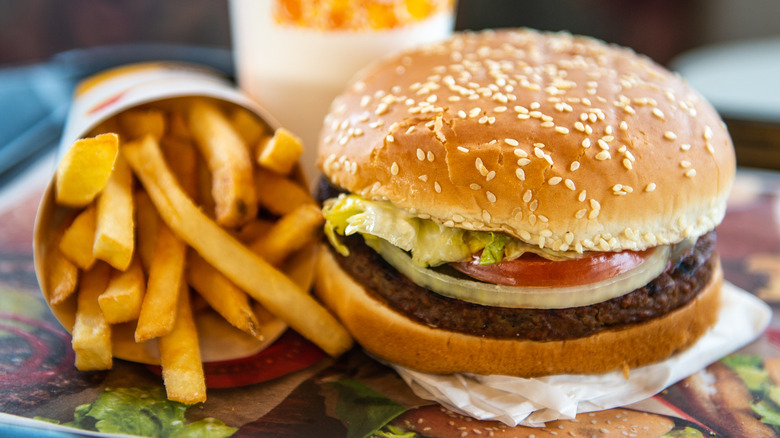 Burger King Whopper and container of fries on a tray