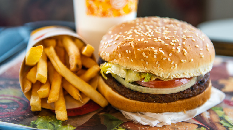 Burger King Whopper and container of fries on a tray