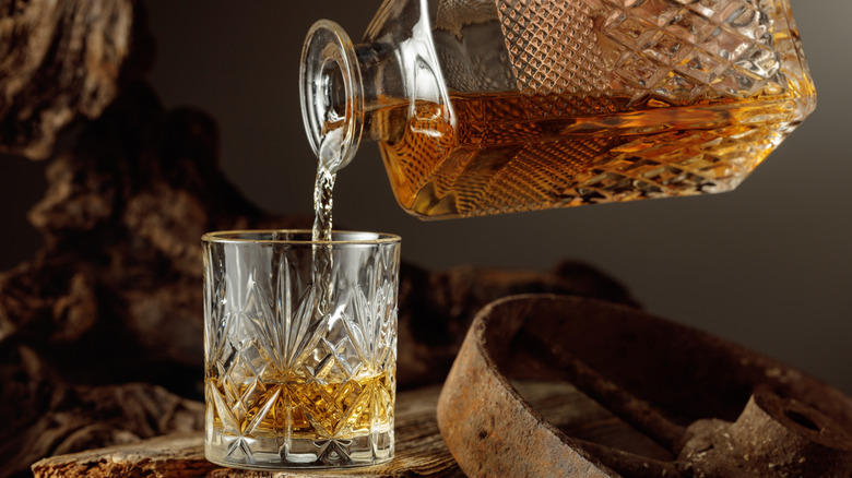 Whiskey poured from decanter into glass