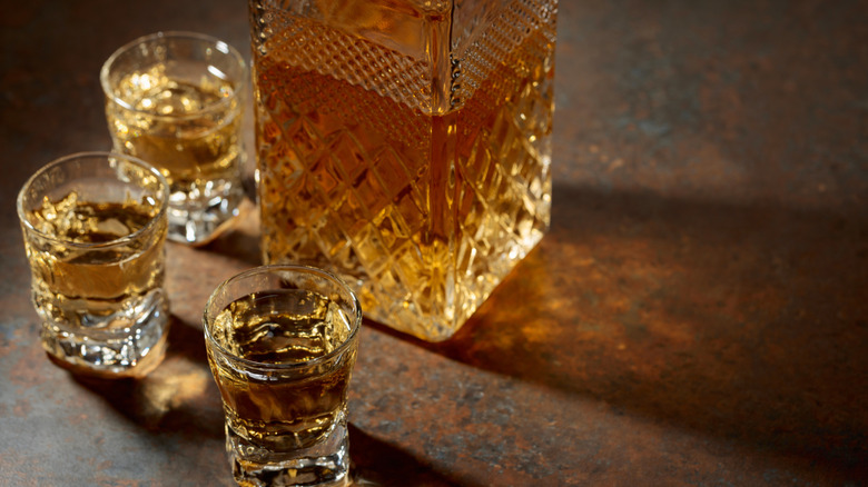 Decanter and small glasses of whiskey