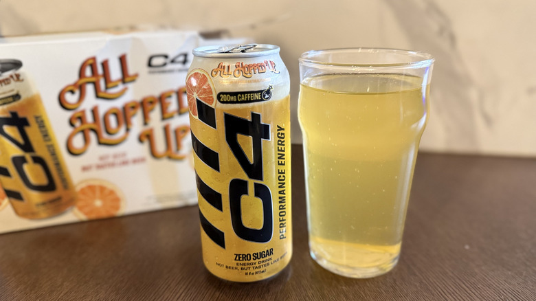C4 All Hopped Up can and poured into a glass with C4 product box behind on table