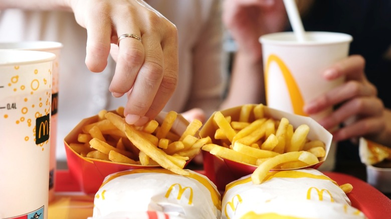 Two people enjoying a meal from McDonald's.