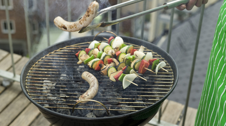 grilling skewers on balcony