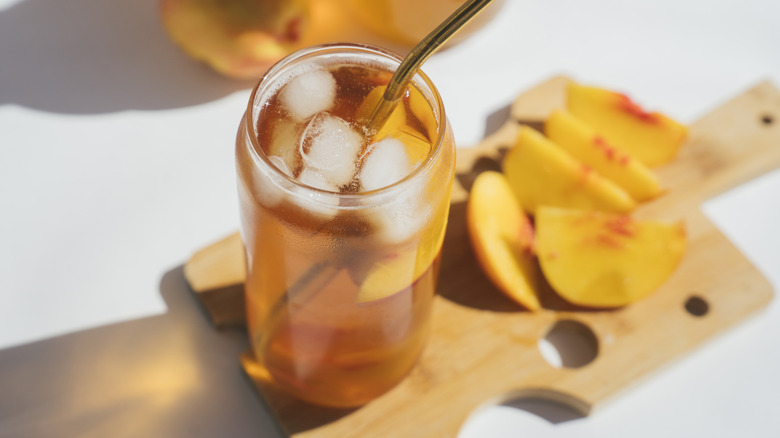 Glass of peach iced tea in sunlight