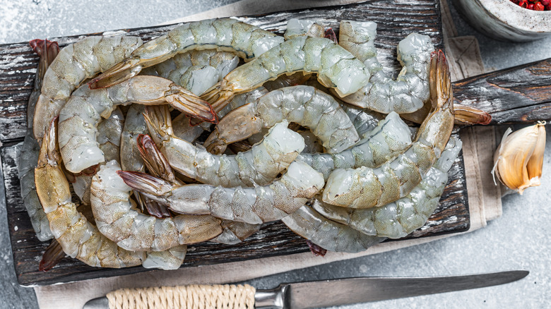 raw shrimp on an old wood cutting board