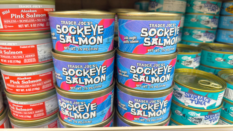 Cans of salmon and tuna on a grocery store shelf