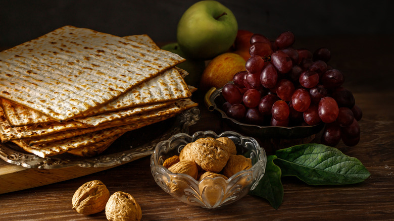 Passover foods including fruit and matzo placed on table.