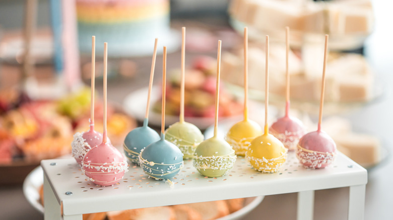 Cake pops in pastel colors decoarated with white sprinkles