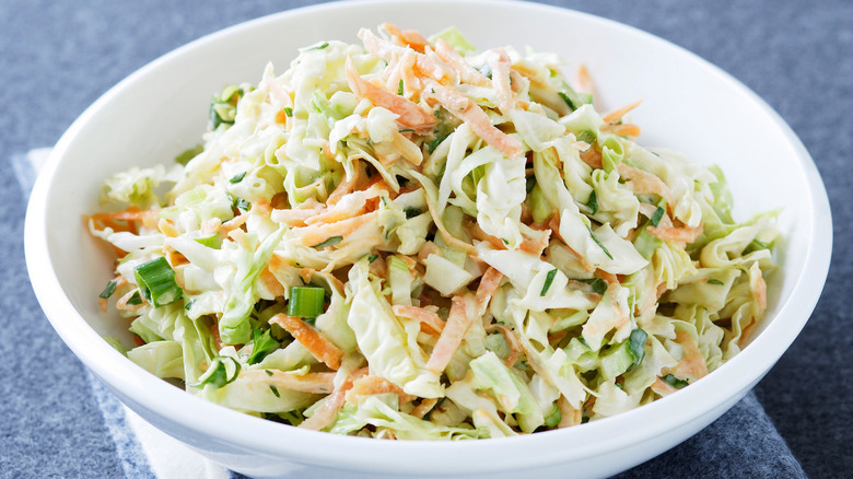 White bowl of cabbage coleslaw
