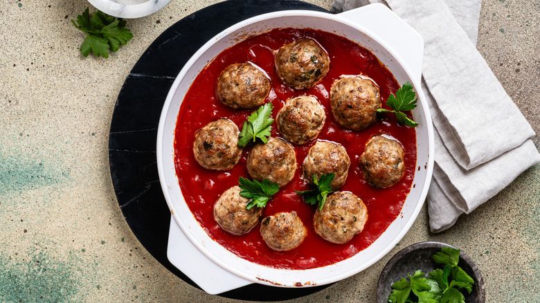 Meatballs in tomato sauce in a white dish