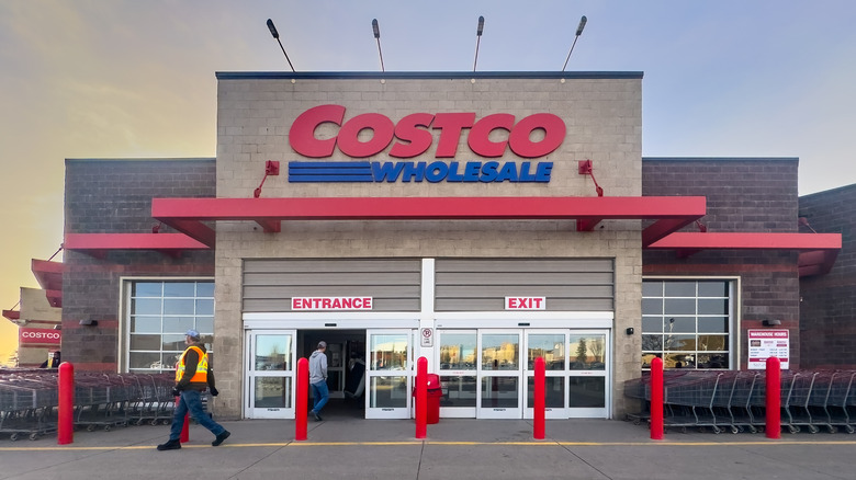 Outside a Costco, with shopping carts on each side of the entrance