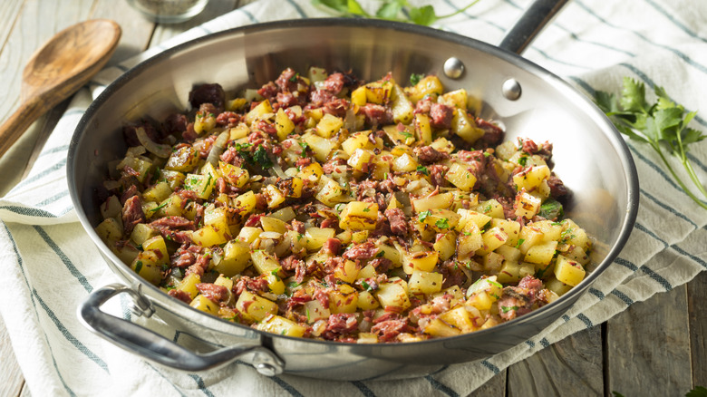 A skillet of corned beef hash sits crispy and ready to eat
