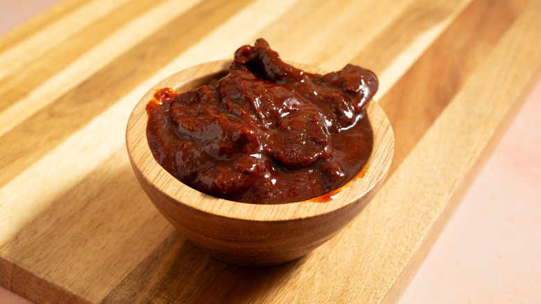 Chipotles in adobo sauce in wooden ramekin