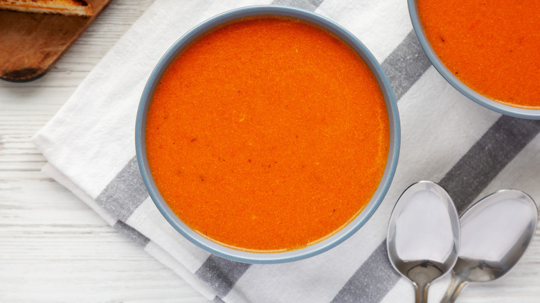 Tomato soup in bowls on table