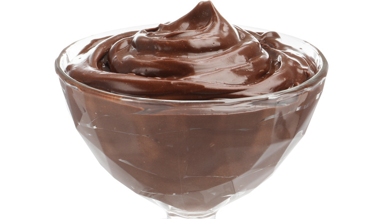 A glass bowl of chocolate pudding