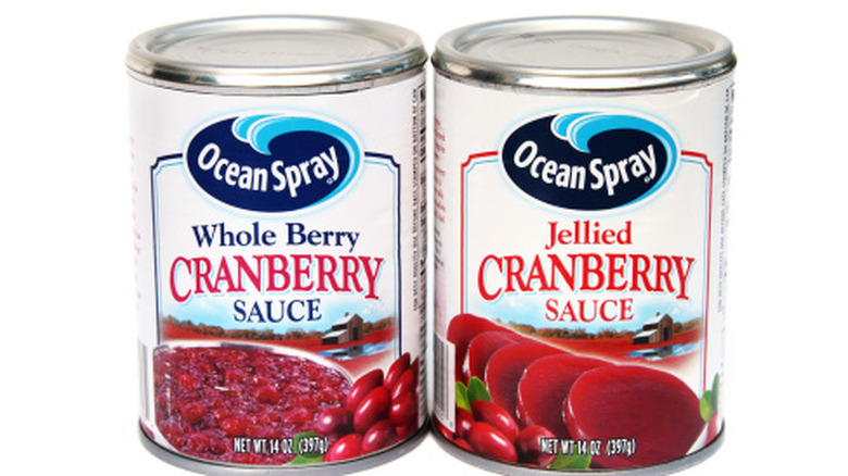 Two cans of cranberry sauce on a white background