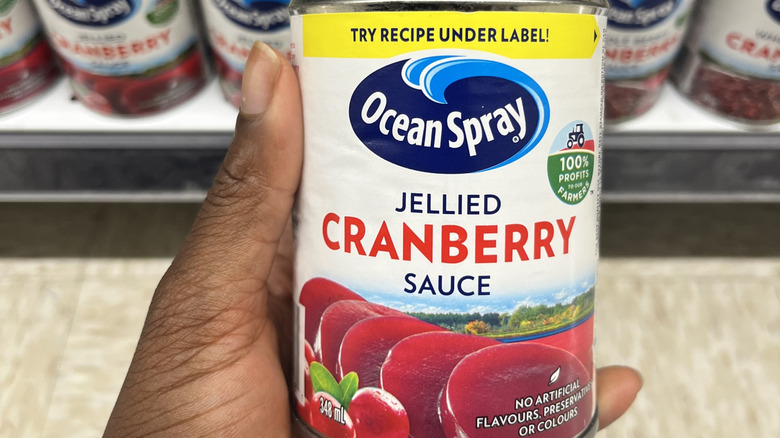 holding can of cranberry sauce