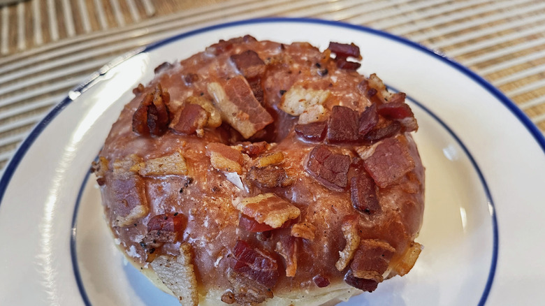 A donut topped with bacon pieces