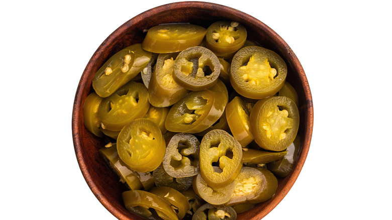 A wood bowl of pickled jalapenos