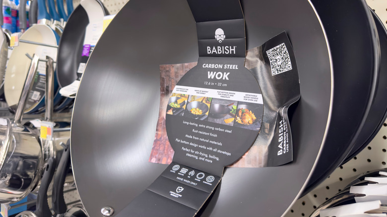 A carbon steel wok at the store hanging on a shelf