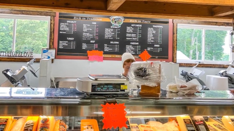 Deli counter with worker making homemade sandwiches at Shiloh General Store.