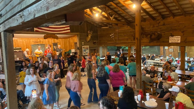 Customers clogging to live music in the dining barn at Sims Country Bar-B-Que.
