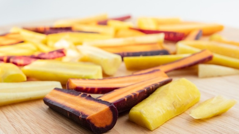 Rainbow carrots that have been cut in half.
