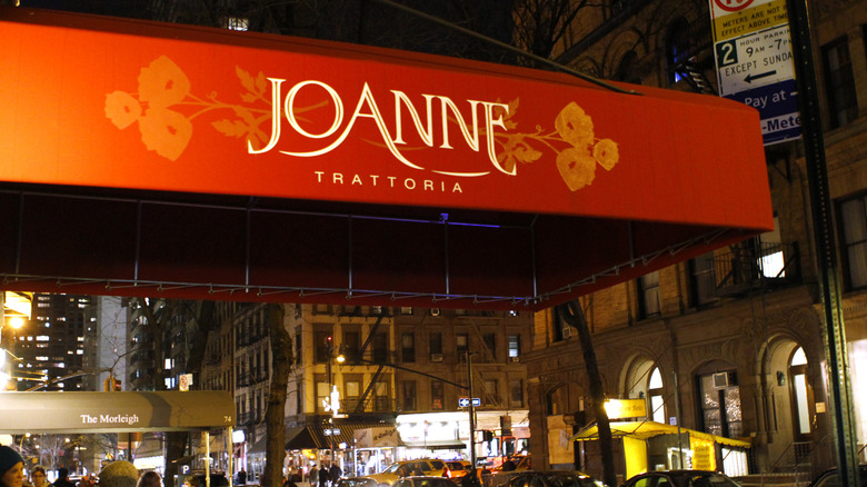 The exterior of Joanne Trattoria in New York City, with a red awning visible.