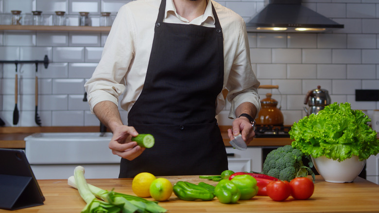 Chef in black apron doing a cooking demonstration