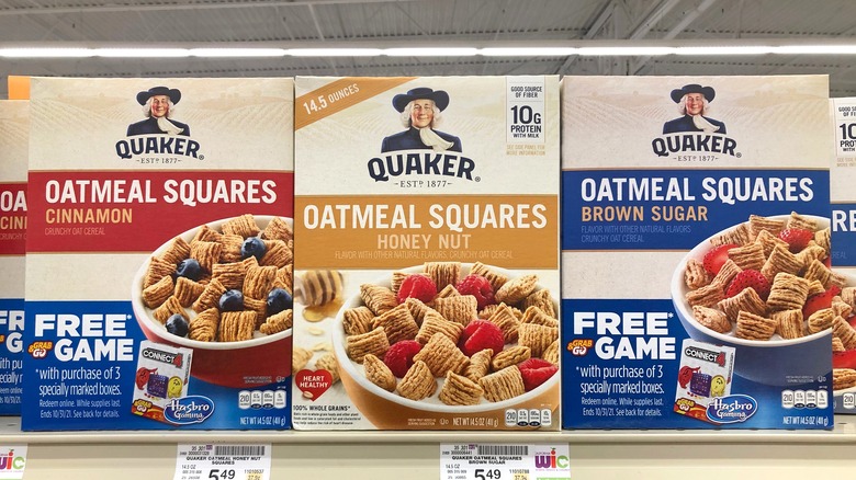 Varieties of Quaker Oatmeal cereal on a shelf at a grocery store