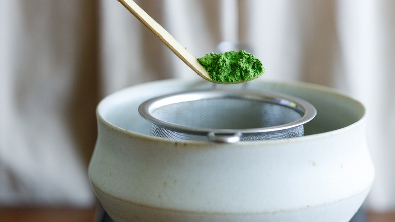 A scoop of green powdered matcha for a Japanese tea ceremony