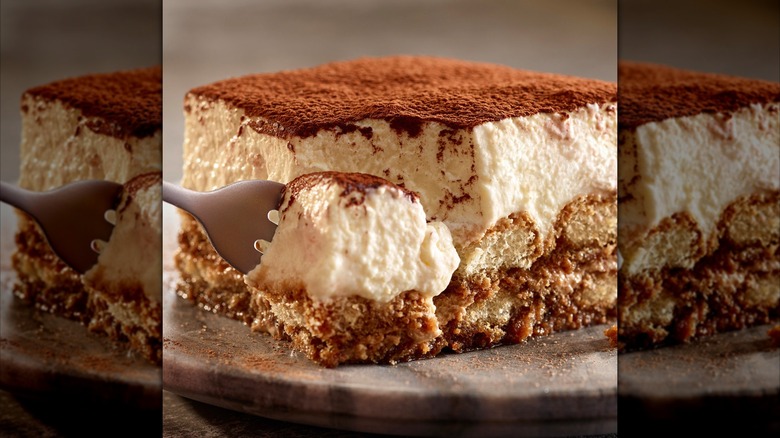 Side view of a slice of tiramisu on gray plate