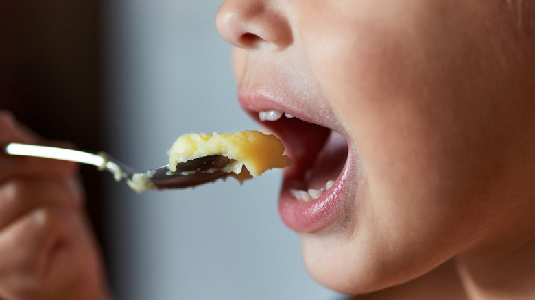 Boy eating mashed potatoes