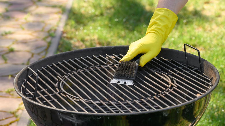 Person cleaning a grill