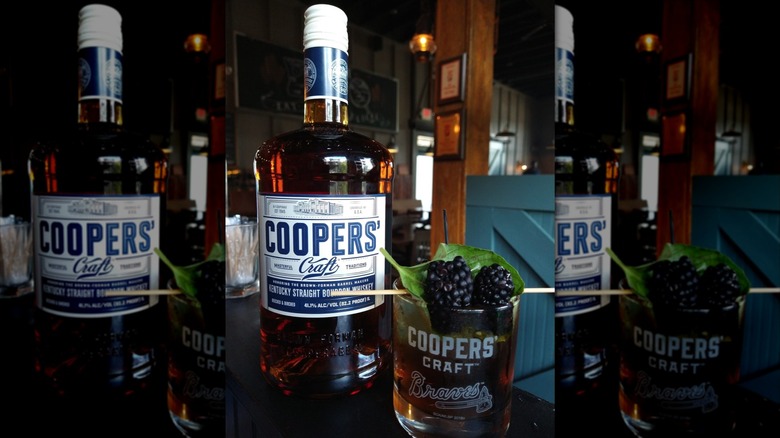 Cooper's Craft Kentucky Straight Bourbon on a table with a glass