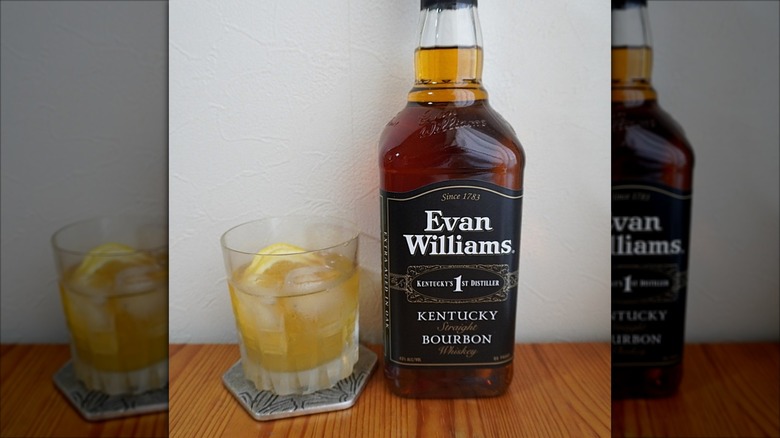 Bottle of Evan Williams Black Label bourbon with glass of bourbon