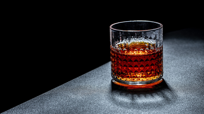 Glass of bourbon on a table