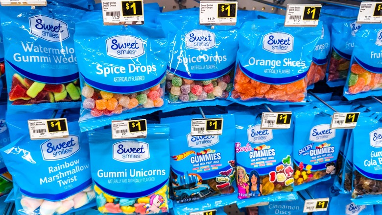 Bags of various Sweet Smiles candy on racks in Dollar General