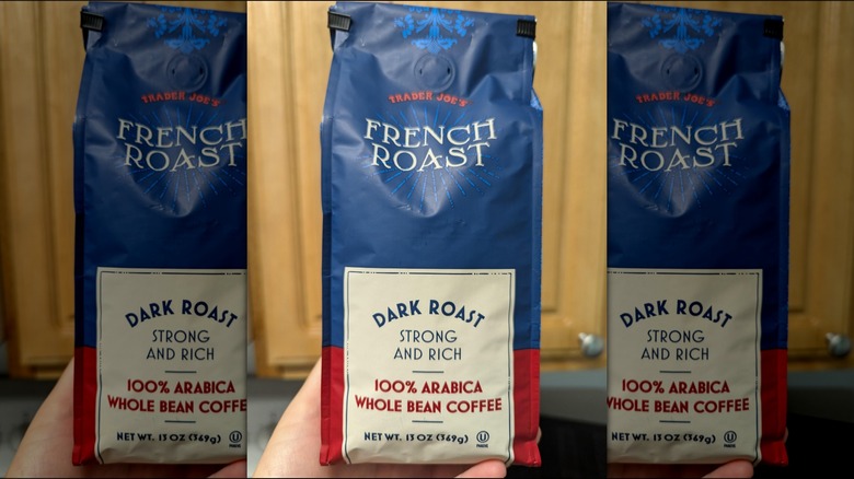 Person holding a bag of Trader Joe's French Roast coffee