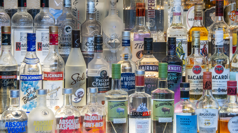 Several bottles of vodka in rows in a bar