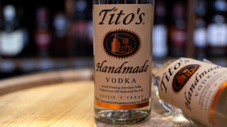 Bottles of Tito's Handmade Vodka on an oak barrel