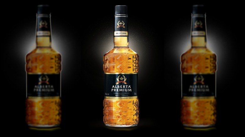 Alberta Premium Blended Rye Whisky three bottles on a black background