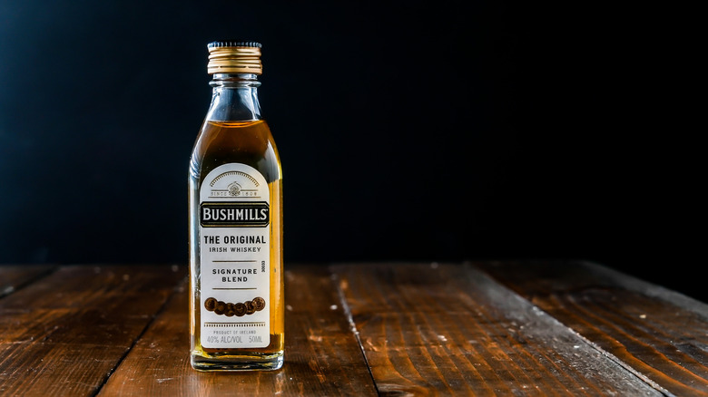 Bottle of Bushmills Original on a wooden table