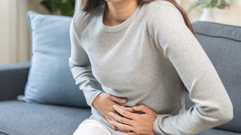 A person clutching their stomach.