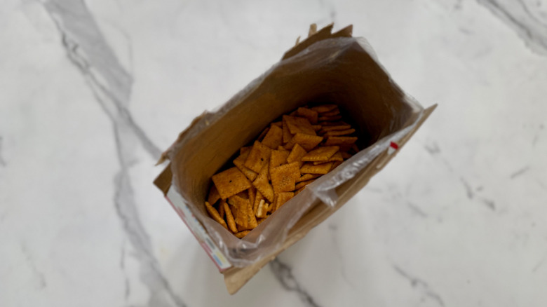 An overhead shot of an opened box of Chili Cheese Dog Cheez-Its on a countertop