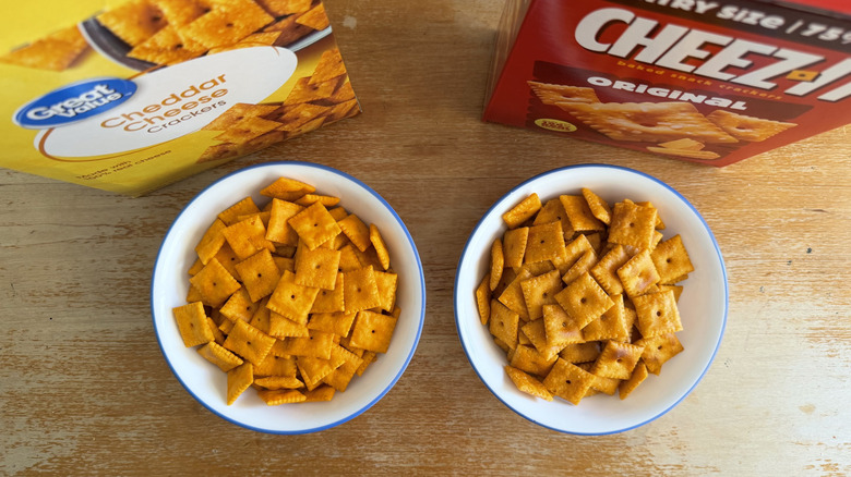 top-down view of small bowls of both cheddar crackers with boxes in background