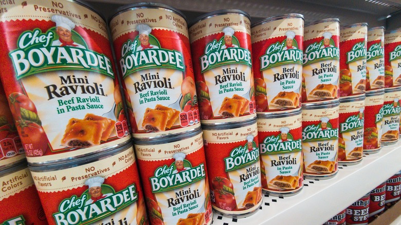 Cans of Chef Boyardee products on a grocery store shelf