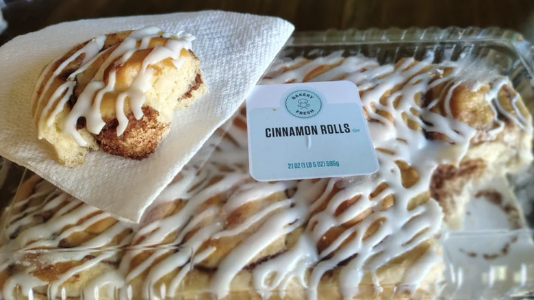Kroger Bakery Fresh Cinnamon Roll package with one sitting on top under a napkin