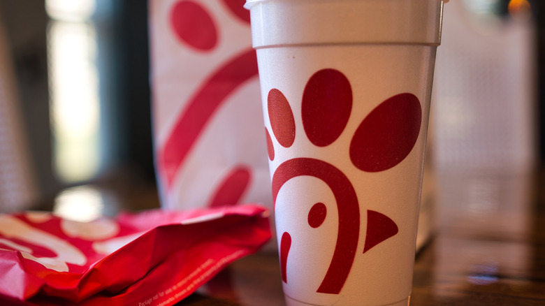 A Chick-Fil-A cup alongside other menu items on a table